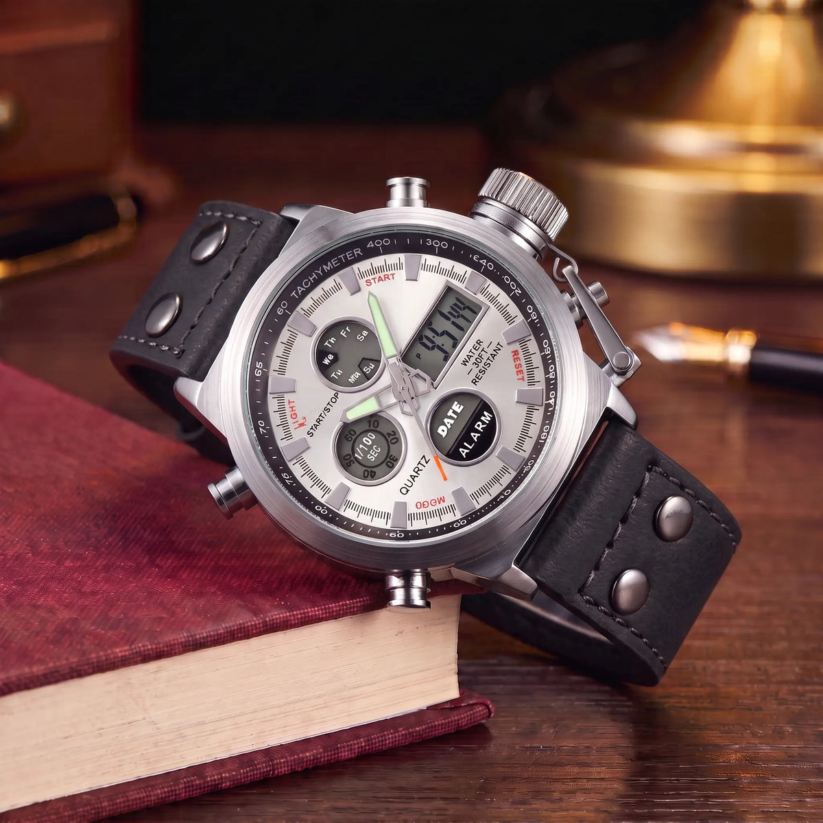 Dual Display Watch with black leather strap, silver case and white dial, analog and digital display, draped over a book stack