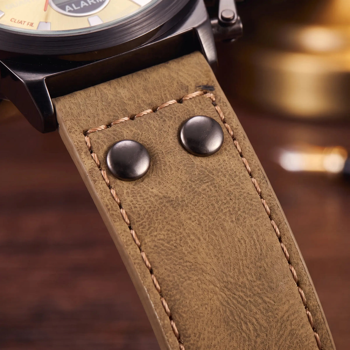 Close up of the khaki leather strap, metal rivets and contrast stitching on the Dual Display Watch
