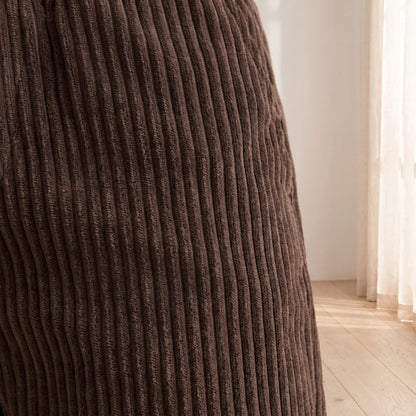 Close-up of the wide wale corduroy texture on the brown trousers