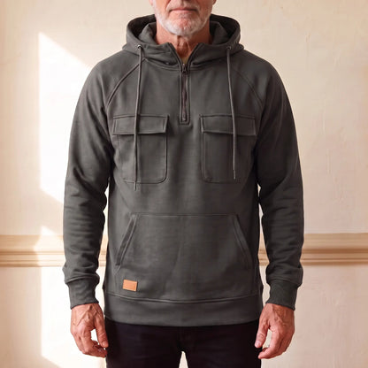 Men's charcoal grey hooded anorak sweatshirt with half zip and twin chest flap pockets, worn