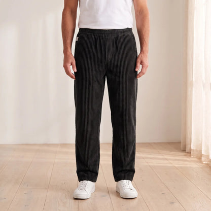 Men's black wide wale corduroy loose straight trousers with elastic waist, worn
