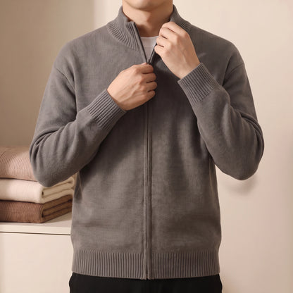 Man wearing knit zip sweater, zipping up