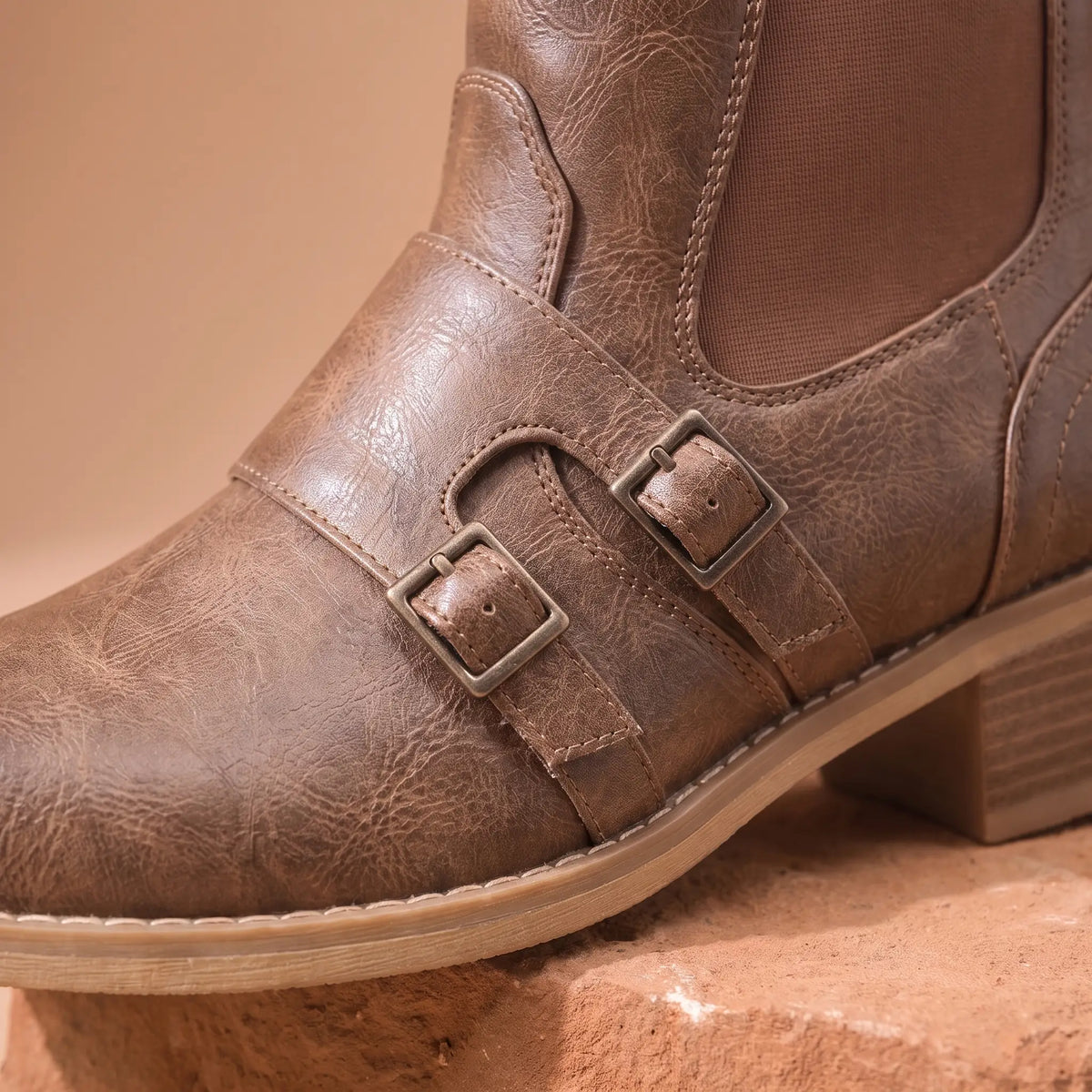 Close up of the two instep buckle straps, stretch side panel and curved stitching on the Grained Finish Boots