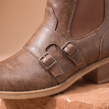 Close up of the two instep buckle straps, stretch side panel and curved stitching on the Grained Finish Boots