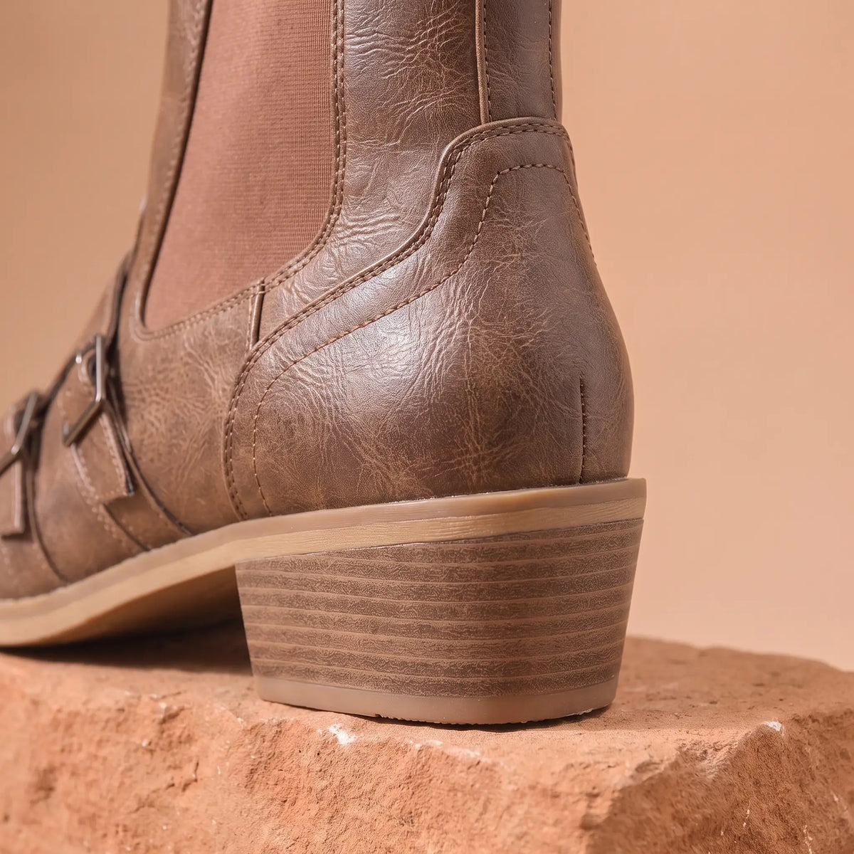 Close up of the stitched heel counter and stacked block heel on the Grained Finish Boots
