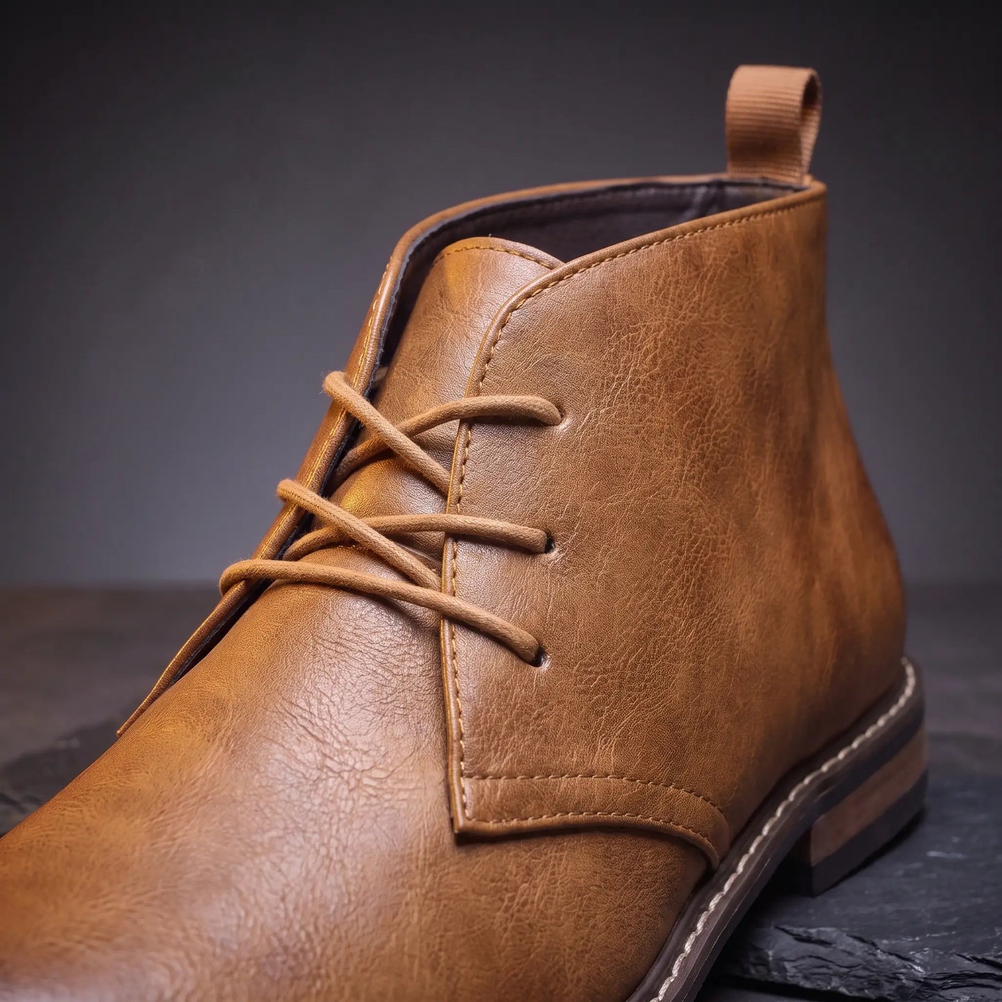 Close up of the three eyelet rows, laces and rear heel pull loop on the Heel Loop Boots