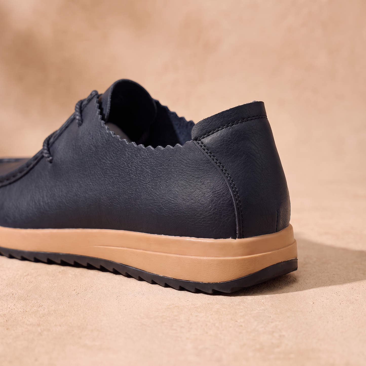 Cushioned Leather Loafers detail - close-up of the heel and tan gum sole with thin black outsole