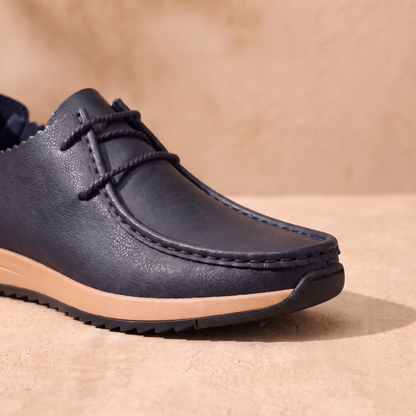 Cushioned Leather Loafers detail - close-up of the moccasin stitching, lace and tan gum sole with thin black outsole