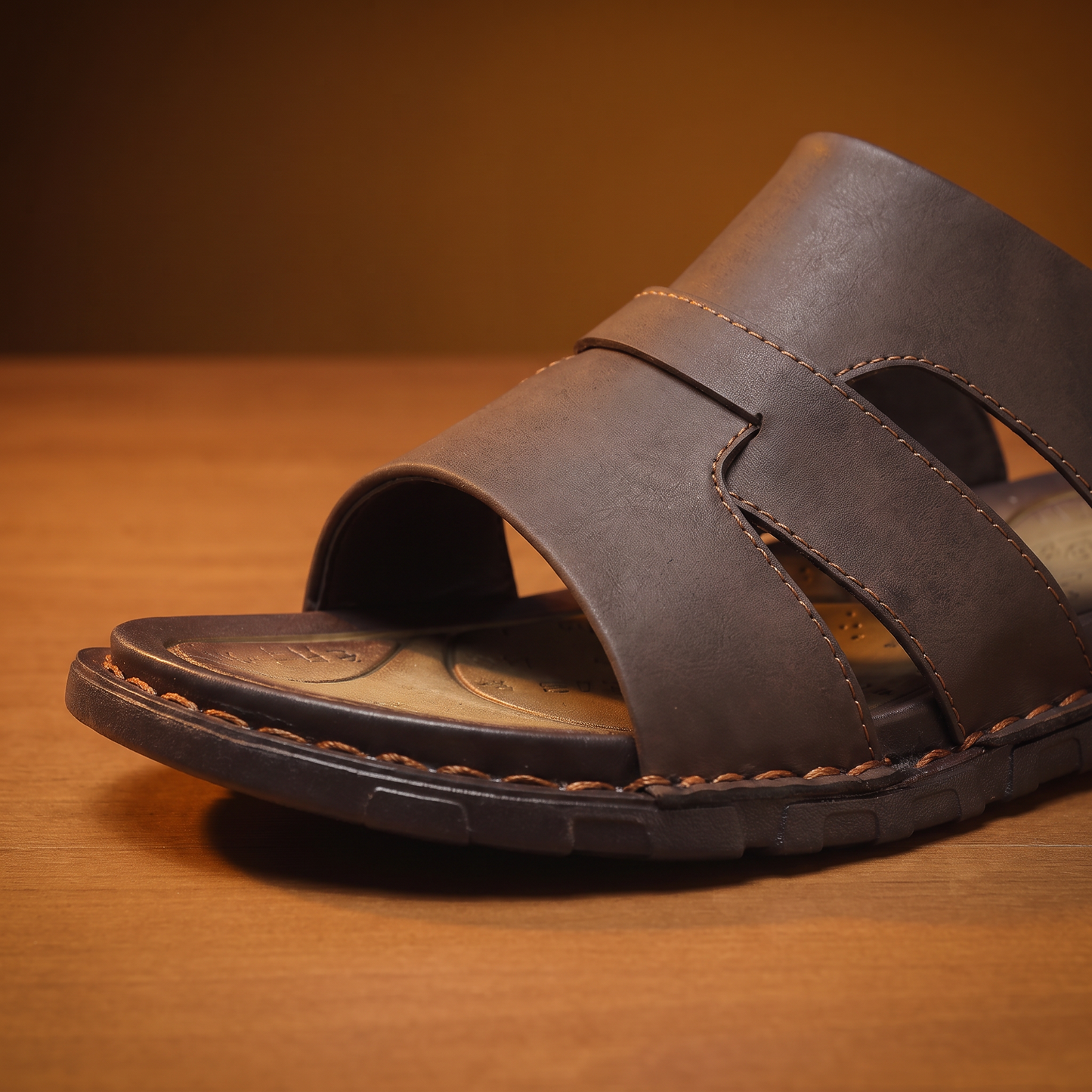 Woven Leather Slides detail - close-up of the woven cross-strap and hand-stitching on the tan cushioned footbed