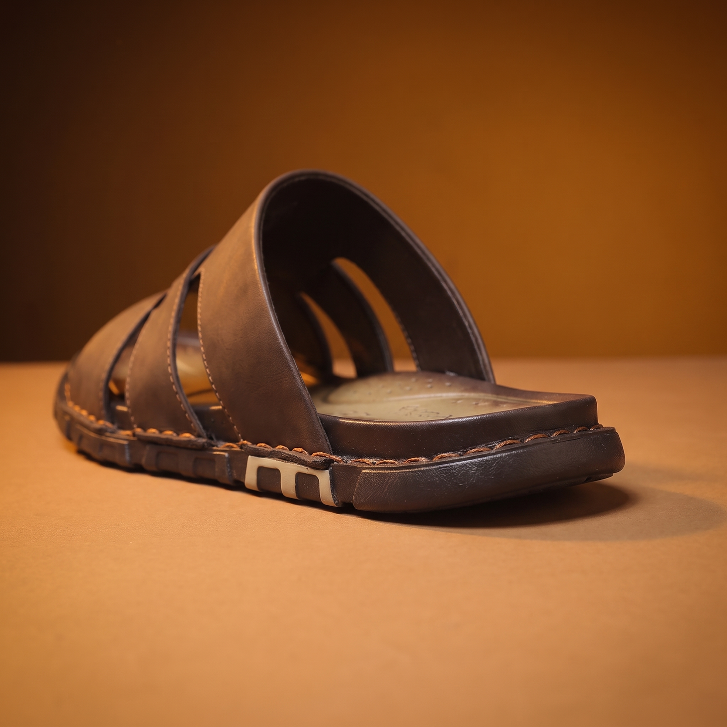 Woven Leather Slides detail - close-up of the open backless heel and chunky rubber sole edge
