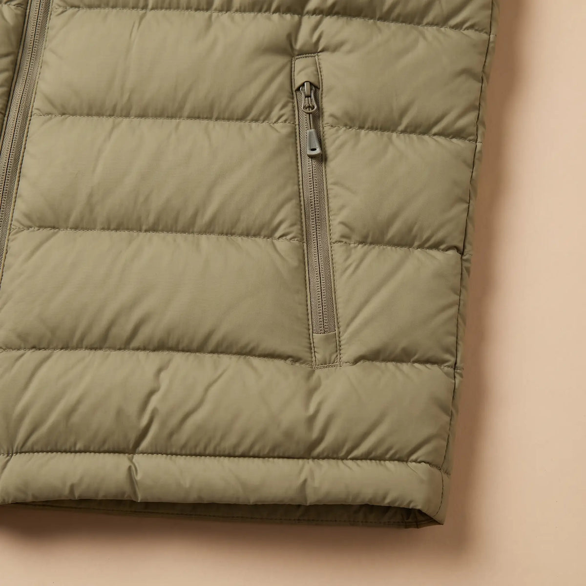 PACKABLE DOWN VEST zip pocket and hem detail