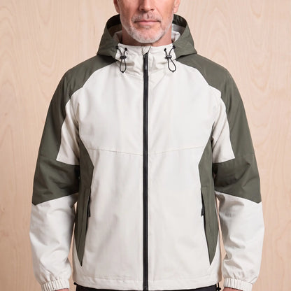 Beige hooded panel windbreaker with olive green colour block panels worn by a man, front view