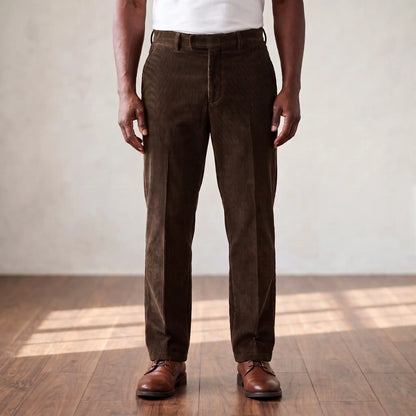 Brown wide wale corduroy straight leg trousers worn with a white tee and brown derby shoes