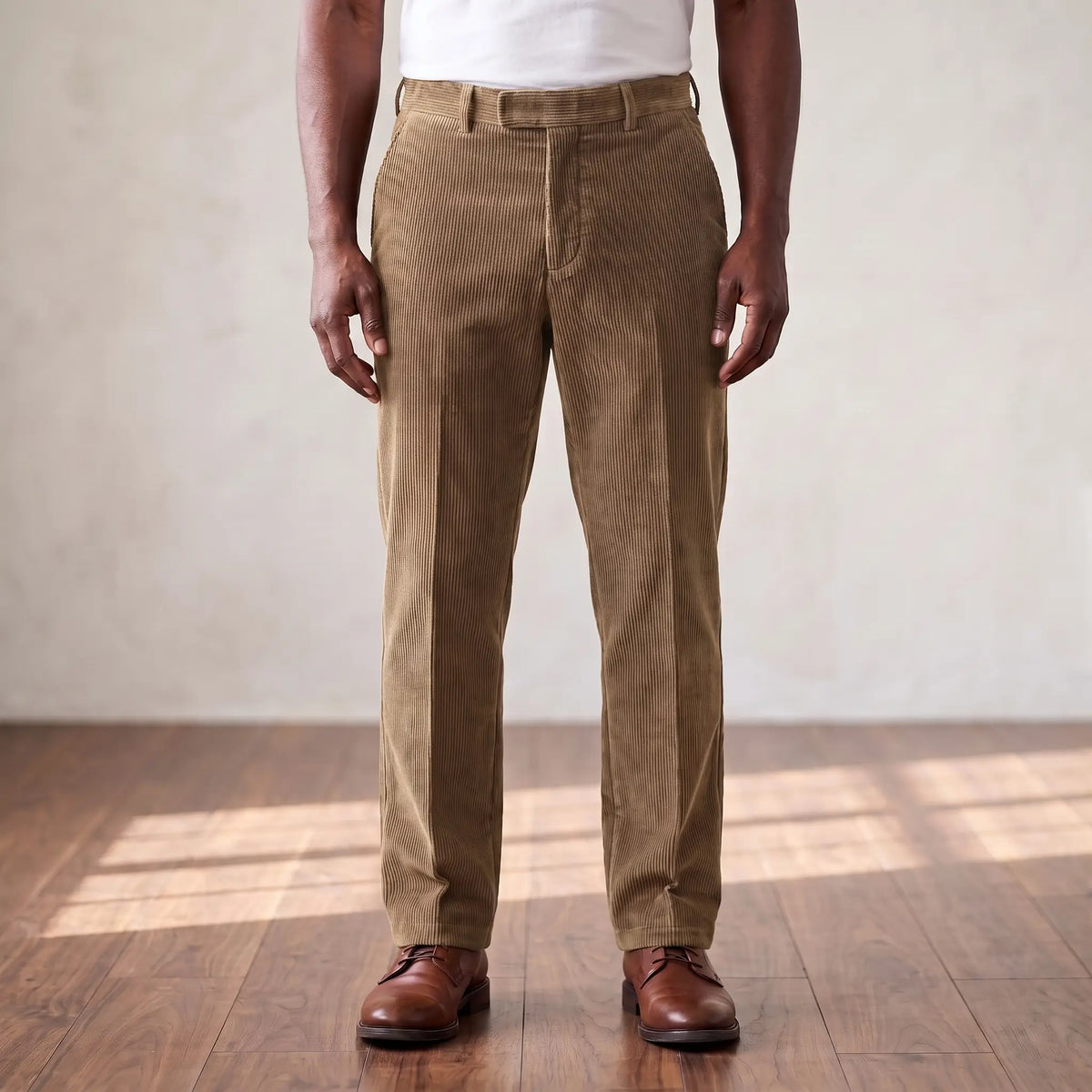 Khaki wide wale corduroy straight leg trousers worn with a white tee and brown derby shoes