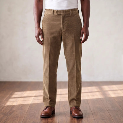 Khaki wide wale corduroy straight leg trousers worn with a white tee and brown derby shoes