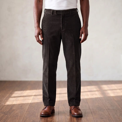 Black wide wale corduroy straight leg trousers worn with a white tee and brown derby shoes