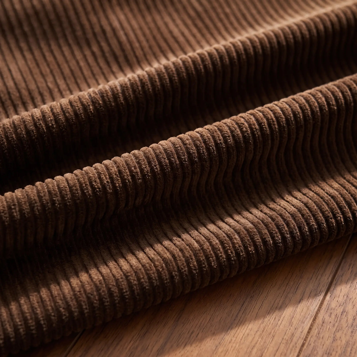 Macro close up of the wide wale corduroy fabric ribs in brown