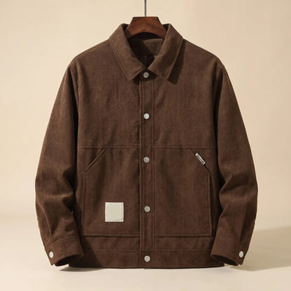 Brown padded corduroy winter jacket with snap front on a wooden hanger, front view