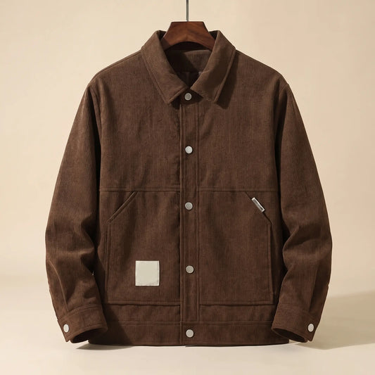 Brown padded corduroy winter jacket with snap front on a wooden hanger, front view