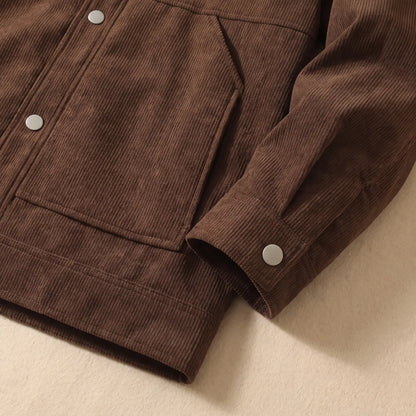 Close up of the winter corduroy jacket hem, slant pocket and snap cuff