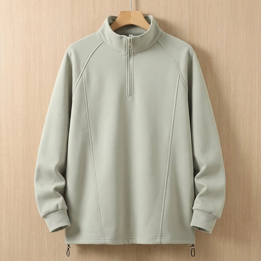 Green oversized half zip sweatshirt with tall collar on a wooden hanger, front view