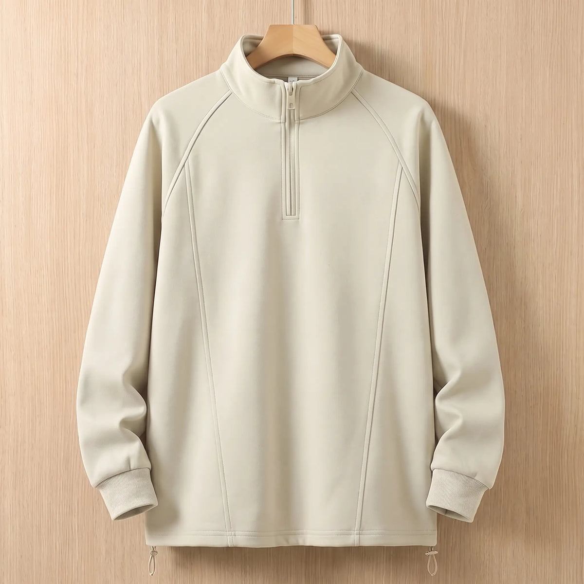 Beige oversized half zip sweatshirt with tall collar on a wooden hanger, front view