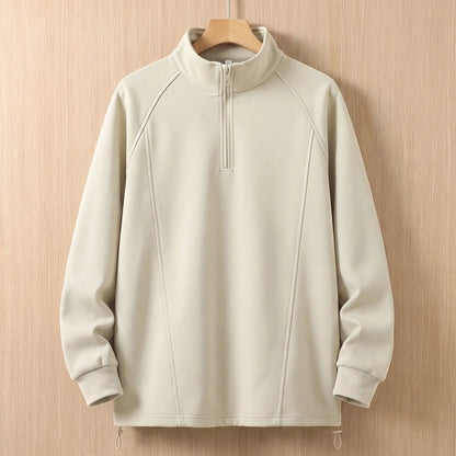 Beige oversized half zip sweatshirt with tall collar on a wooden hanger, front view