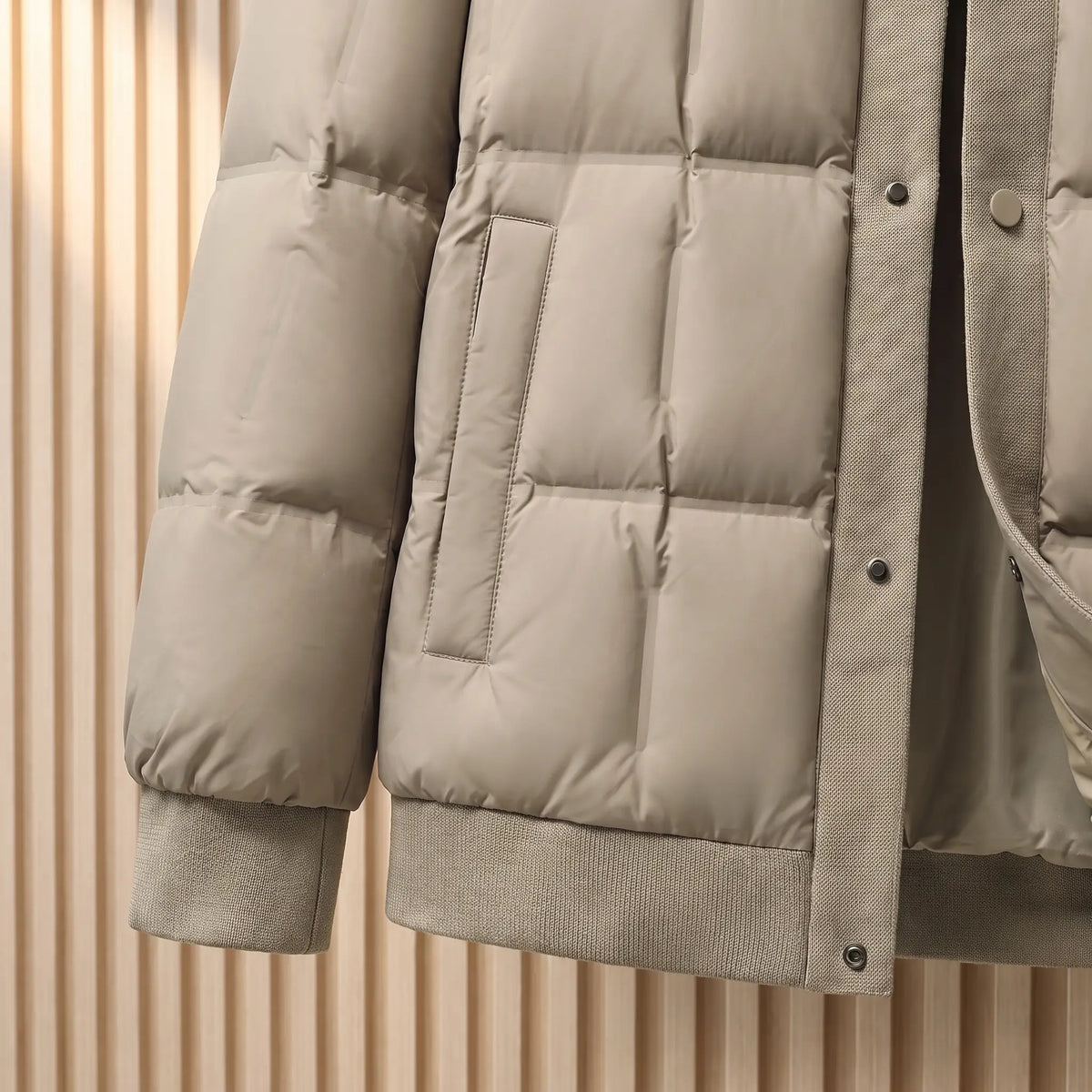 Close up of the ribbed knit hem, front pocket and cuff