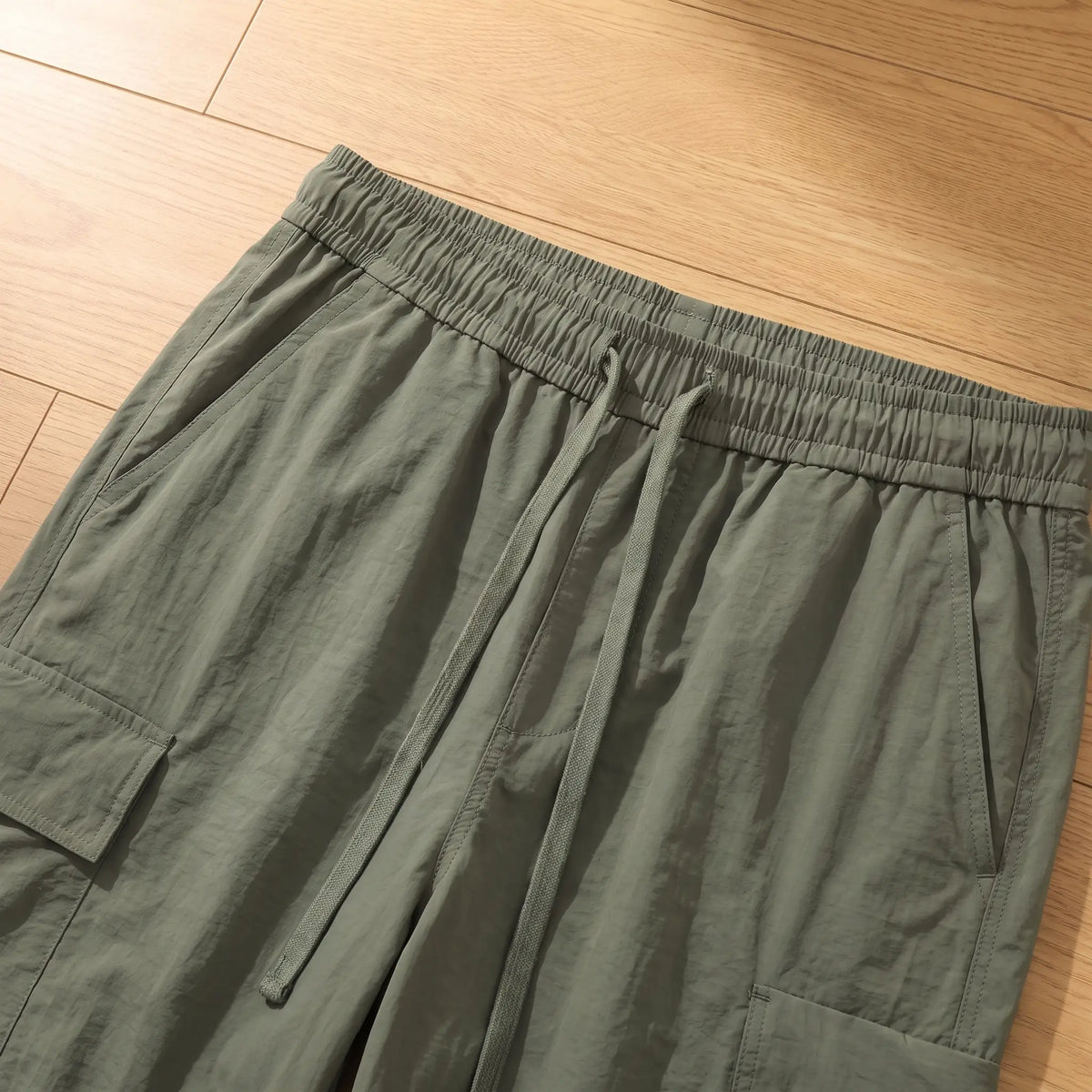 Close up of the elastic waistband, drawcord and side pocket on the trousers