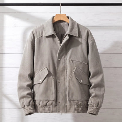 Light grey corduroy bomber jacket with snap front placket on a wooden hanger, front view