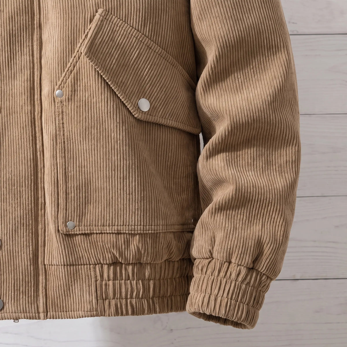 Close up of the waist flap pocket, ribbed hem and ribbed cuff