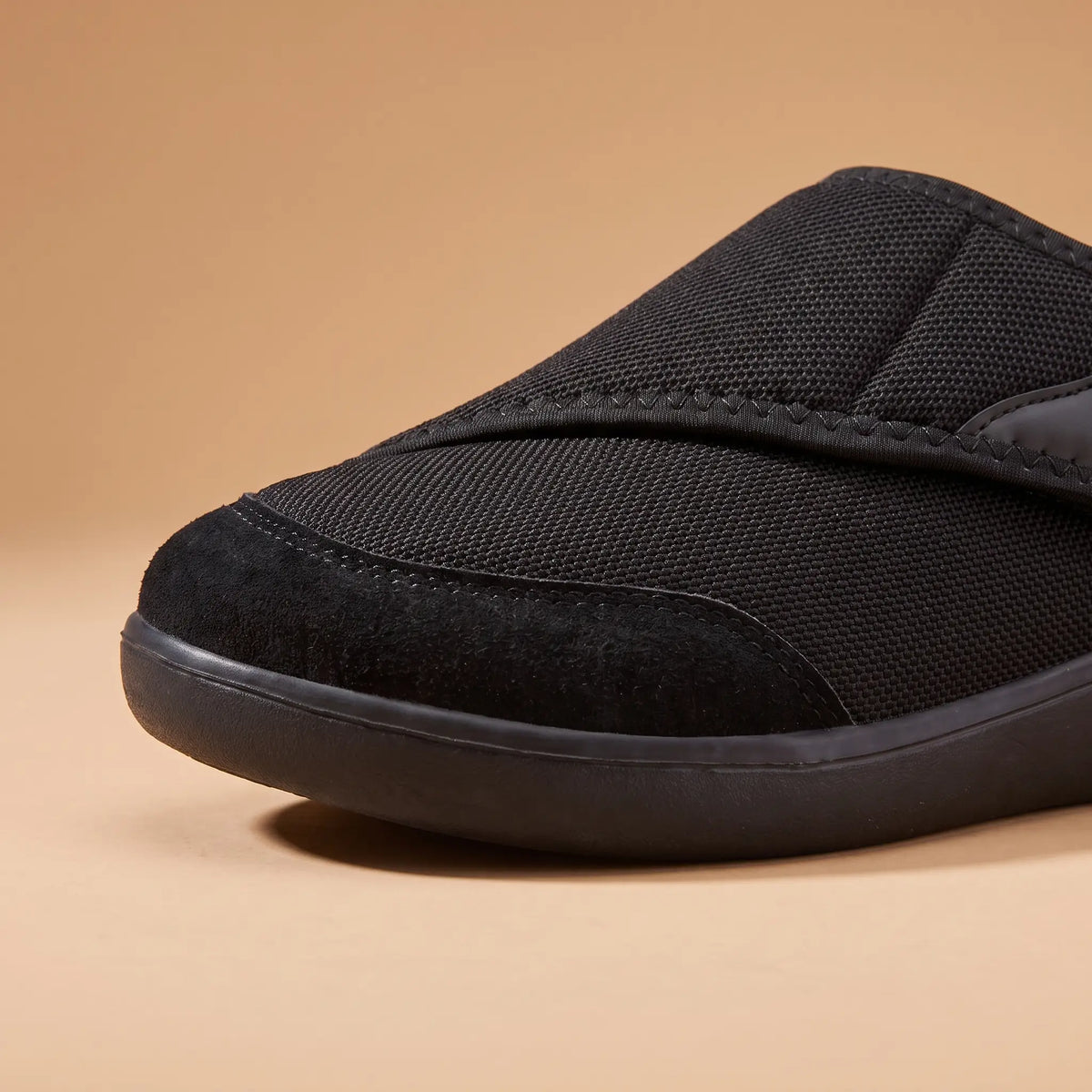 Close-up of the toe cap and sole on the black slip-on shoe