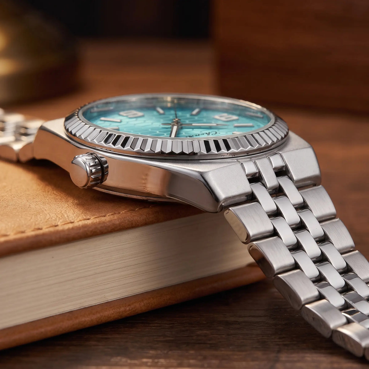 Honeycomb dial watch crown and steel bracelet detail