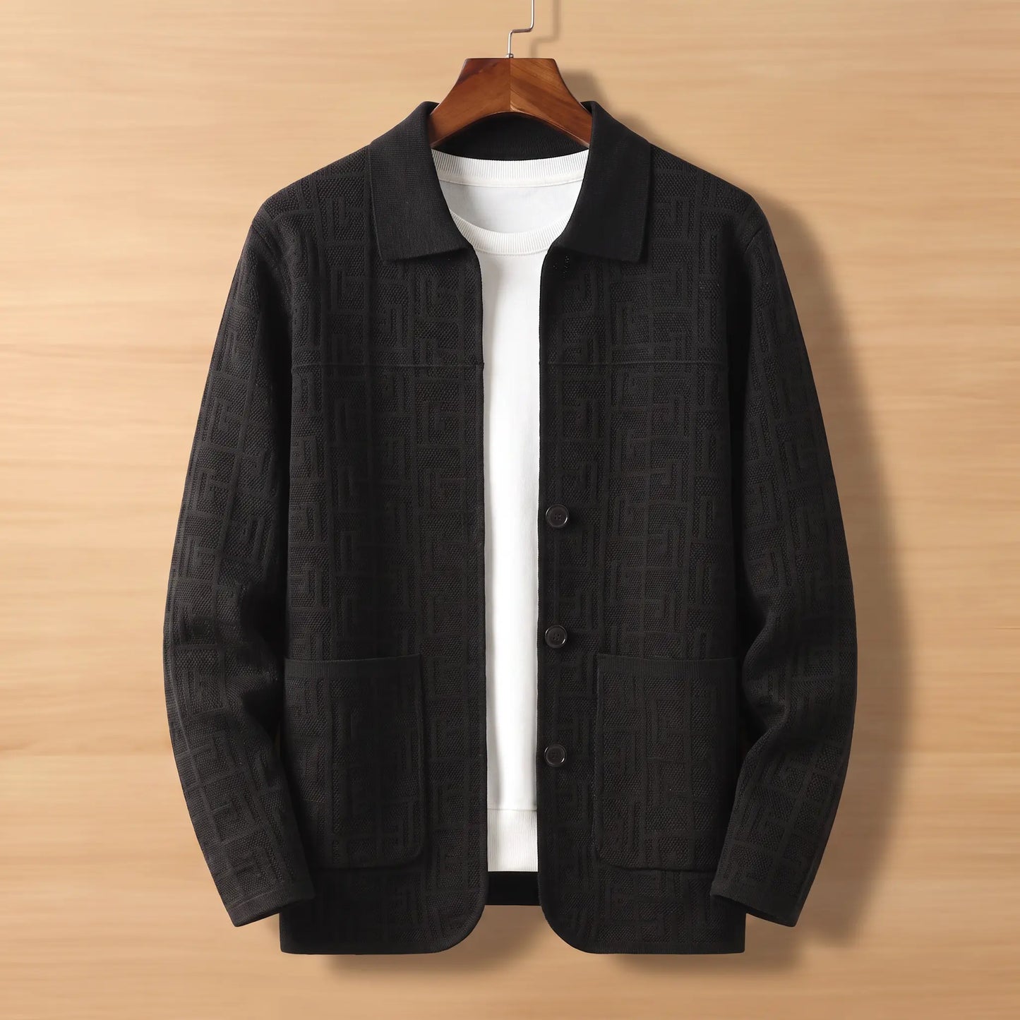 Black jacquard knit cardigan on wooden hanger