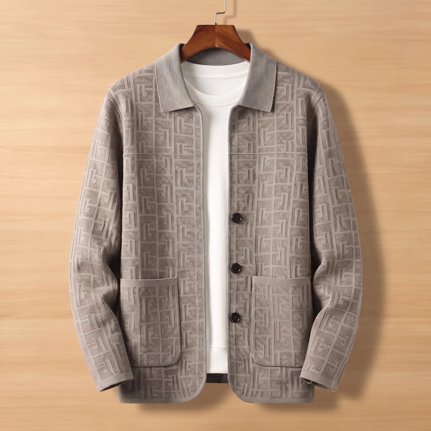 Gray jacquard knit cardigan on wooden hanger