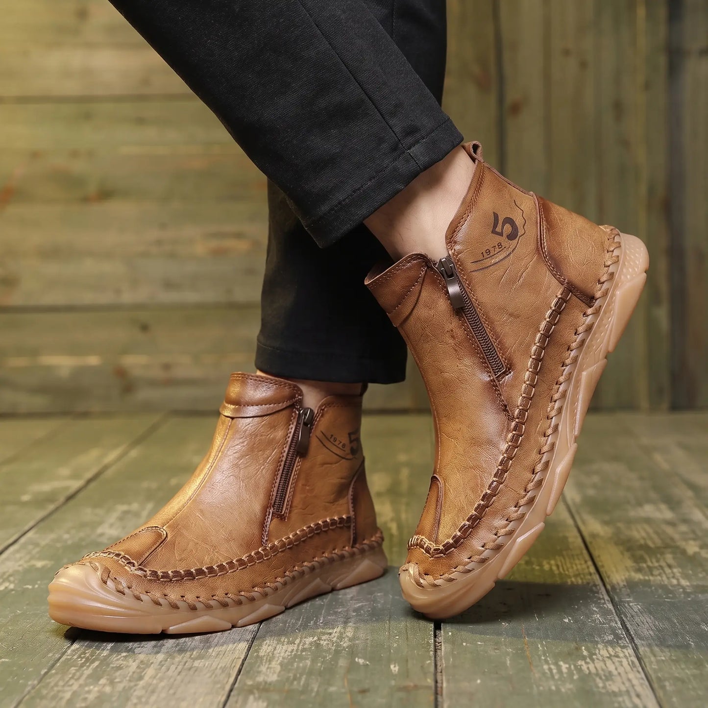 Man wearing Moccasin Seam Boots with dark trousers on a warm wood floor