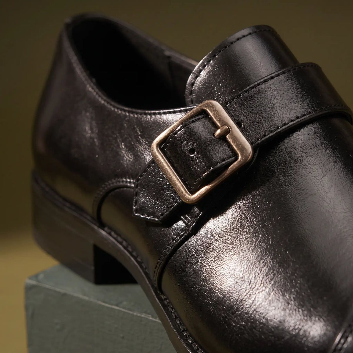 Close up of the monk strap and metal buckle on the Monk Gloss Finish Shoes