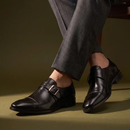 Man wearing the Monk Gloss Finish Shoes with suit trousers, ankles crossed