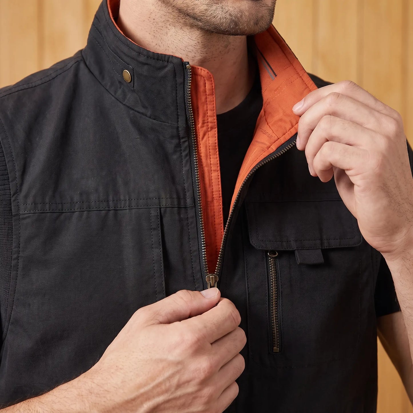 Man zipping up the utility vest