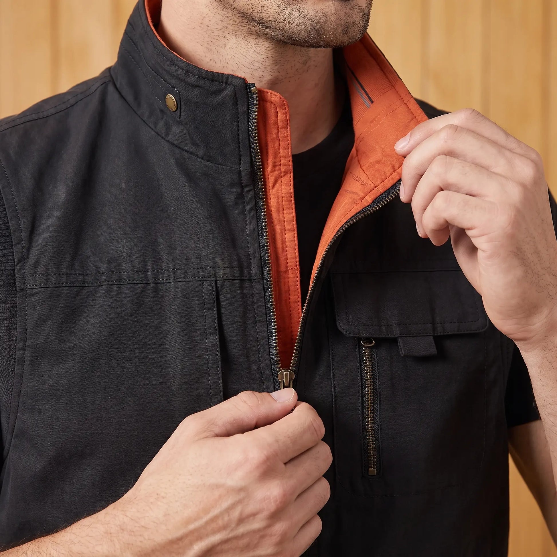 Man zipping up the utility vest