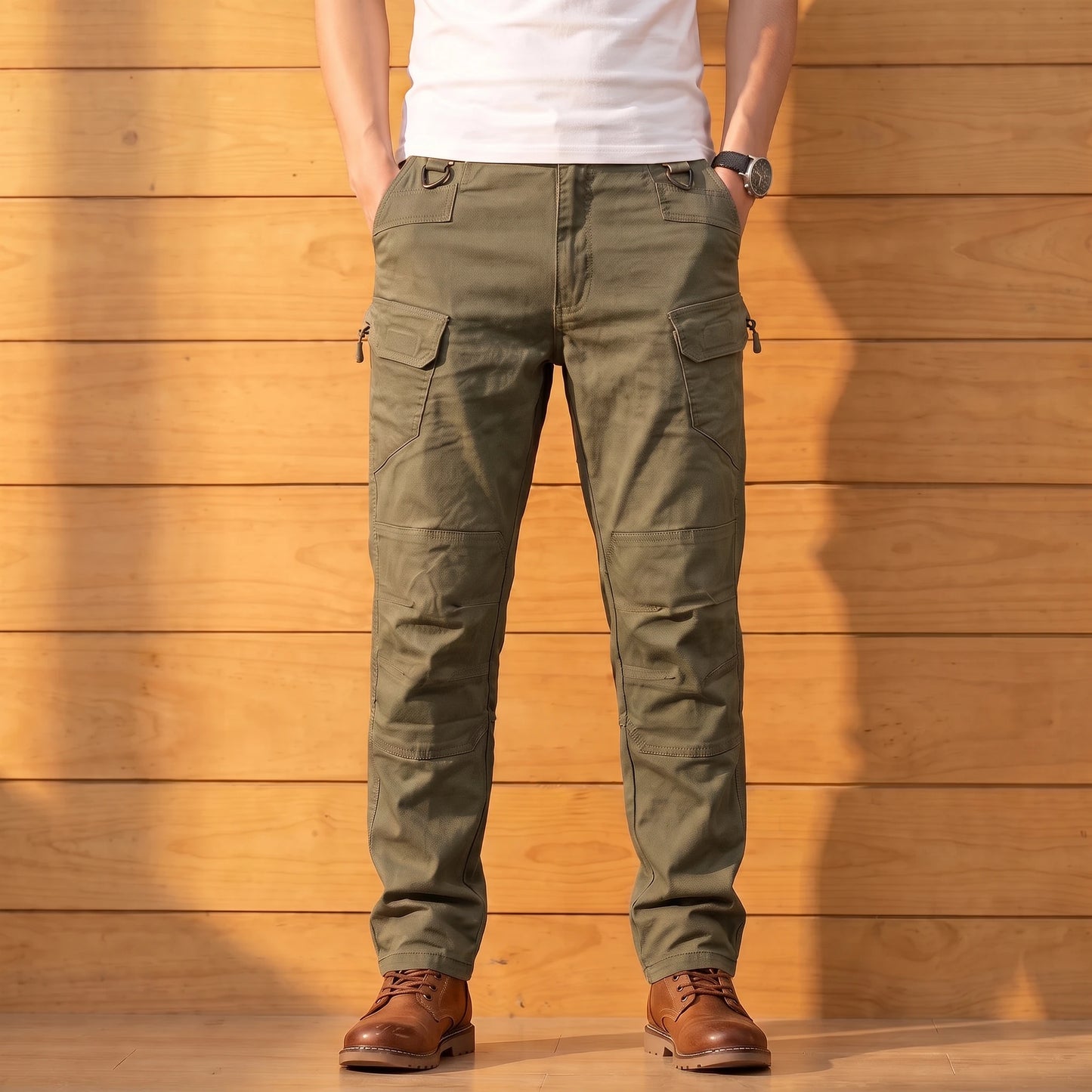 Multipocket cotton cargo pants in olive green, worn front view against a warm wood wall