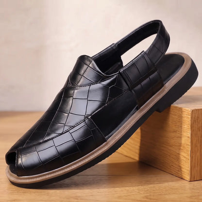 Open Back Sandals in black, a peep toe slingback sandal in croc embossed leather with a side cut out, on an oak display block
