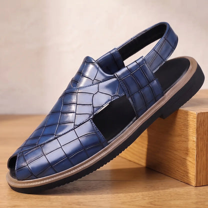 Open Back Sandals in blue, a peep toe slingback sandal in croc embossed leather with a side cut out, on an oak display block