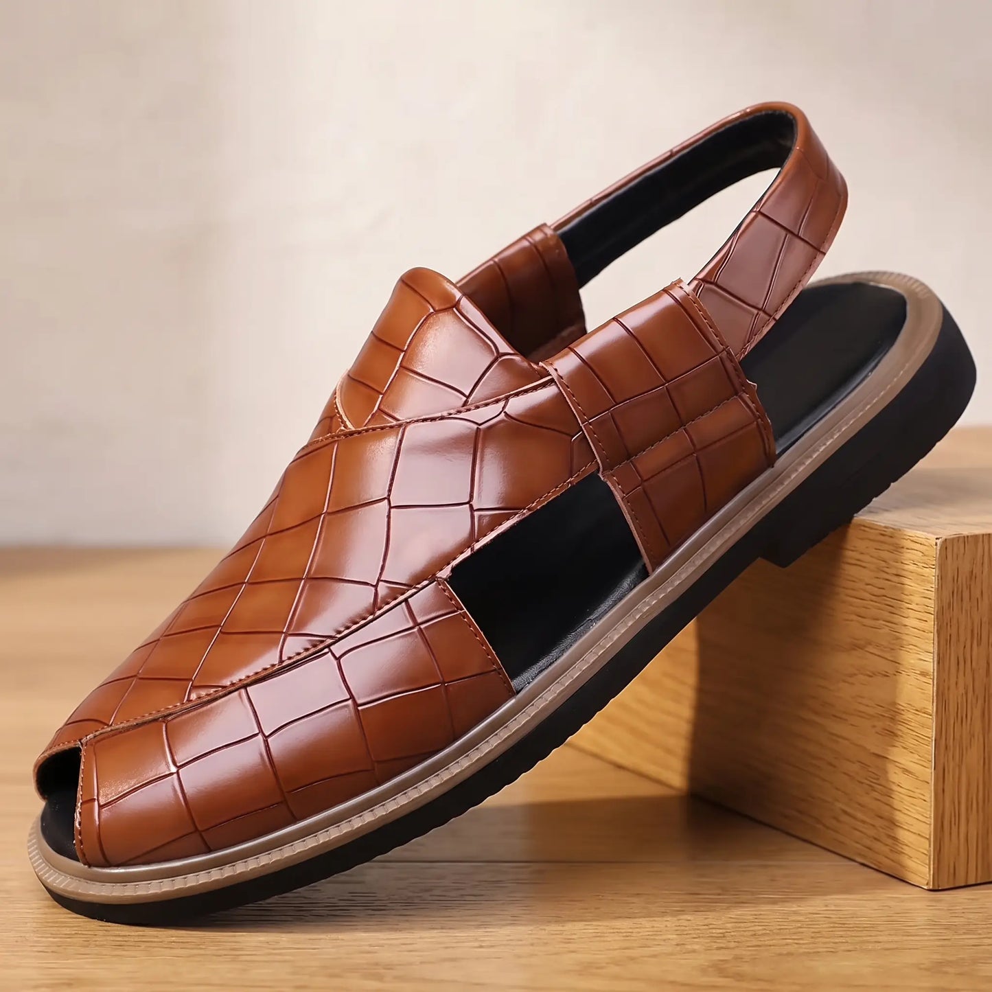 Open Back Sandals in brown, a peep toe slingback sandal in croc embossed leather with a side cut out, on an oak display block