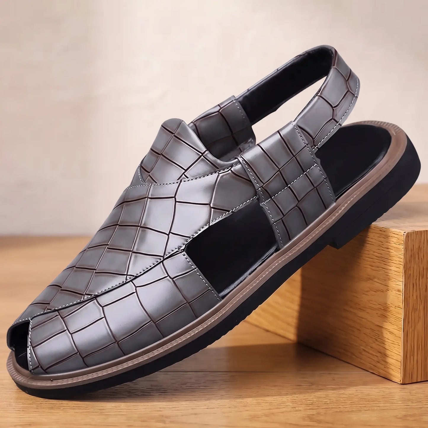 Open Back Sandals in grey, a peep toe slingback sandal in croc embossed leather with a side cut out, on an oak display block