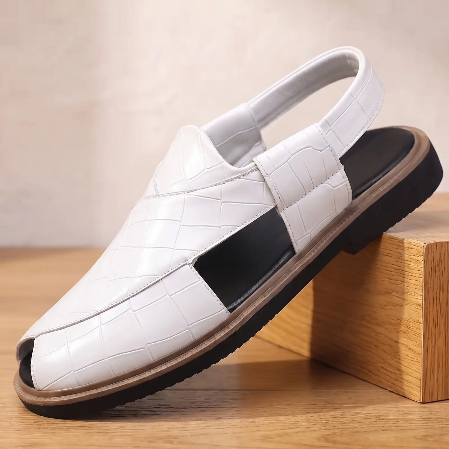 Open Back Sandals in white, a peep toe slingback sandal in croc embossed leather with a side cut out, on an oak display block