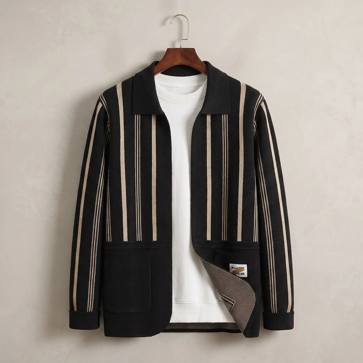 Open Front Cardigan in black with beige stripes, a vertically striped knit cardigan with a turn down collar and two patch pockets on a wooden hanger