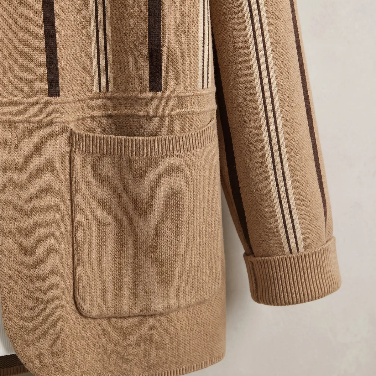 Close up of the front patch pocket and folded ribbed cuff on the khaki Open Front Cardigan