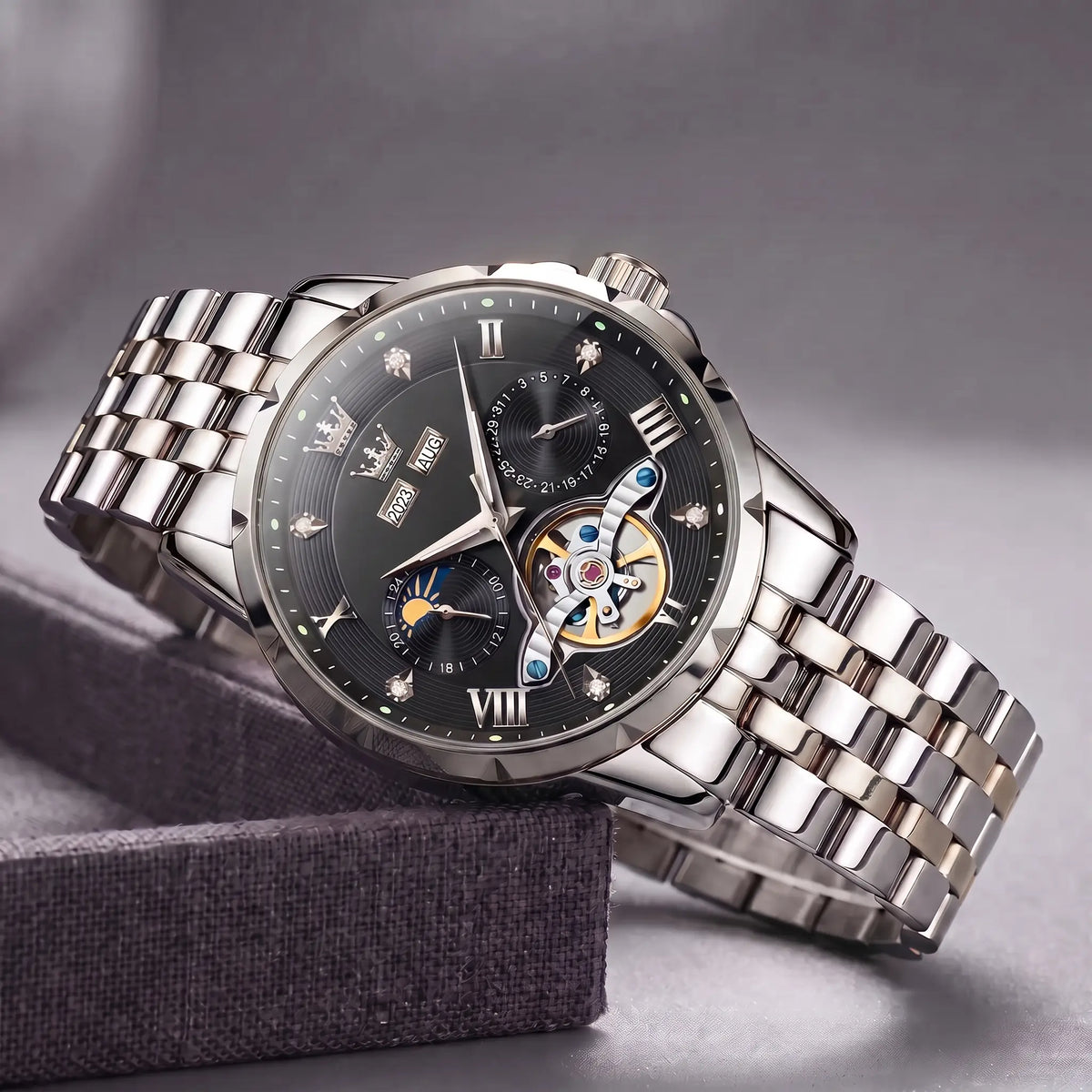 Open Heart Watch with silver steel case, black dial, moon phase and exposed gear window, on a steel band