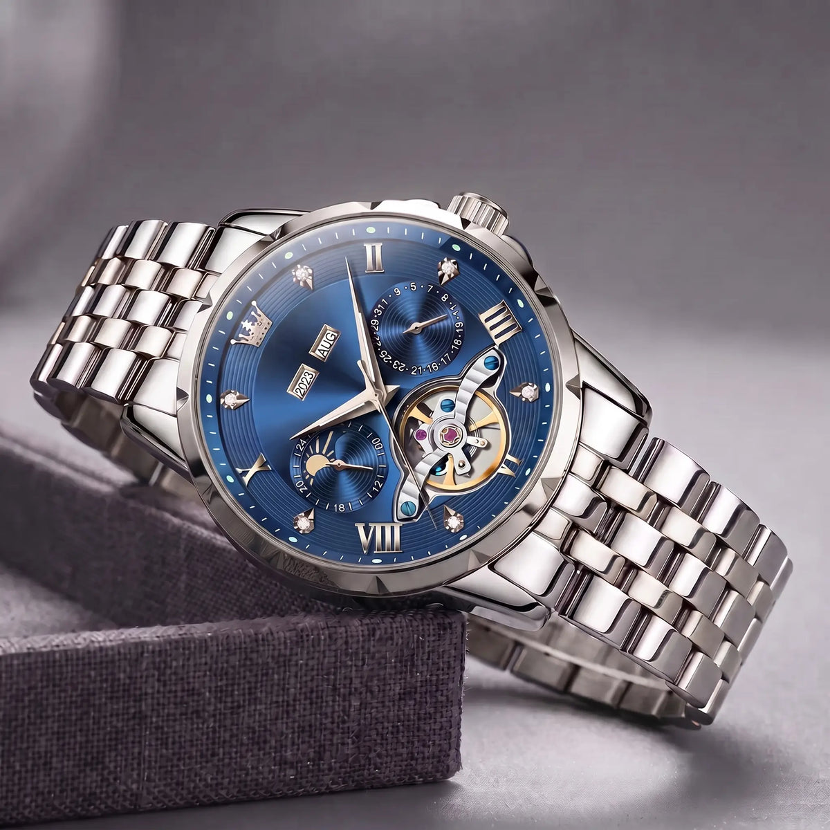 Open Heart Watch with silver steel case, blue dial, moon phase and exposed gear window, on a steel band